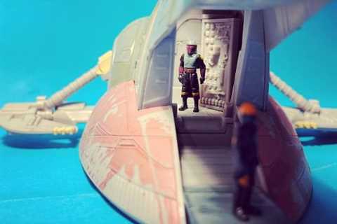 Boba Fett overlooks the loading ramp of his ship Slave I while...